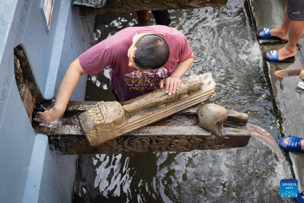 A man cleans a stone waterspout on the occasion of the Sithi Nakha Festival in Lalitpur, Nepal, June 12, 2024. The Newar community celebrates the Sithi Nakha festival to mark the beginning of monsoon season by cleaning water sources such as ponds, wells and stone spouts. People also prepare traditional pancakes such as Bara and Chatamari as a tribute to their ancestral god.(Photo: Xinhua)