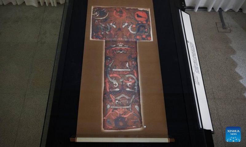 This photo taken on June 14, 2024 shows a T-shaped painting on silk unearthed from Lady Xin Zhui's tomb, now displayed at the Hunan Museum in Changsha, central China's Hunan Province.  (Photo: Xinhua)