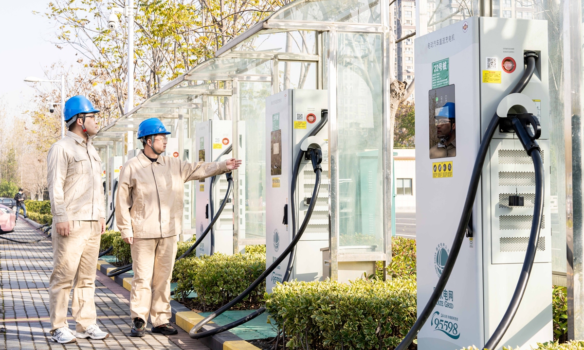 Workers inspect the charging stations.