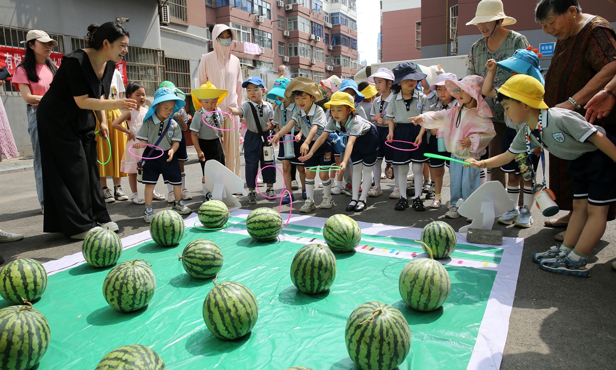 Children play a game with watermelons and enjoy the summer in Lianyungang, East China's Jiangsu Province on June 19, 2024. Photo: VCG