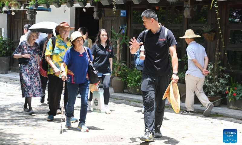 Lin Yinan (1st R, front), an associate professor at East China University of Science and Technology, introduces architecture history to foreign guests in Kuliang, Fuzhou, southeast China's Fujian Province, June 22, 2024. Kuliang, or Guling in Mandarin, is situated on the outskirts of Fuzhou. Since 1886, people from more than 20 countries began to build villas in Yixia Village in Kuliang to spend the summer. (Photo: Xinhua)