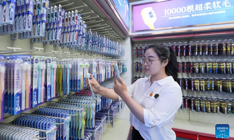 A staff member introduces toothbrushes for foreign clients via livestream at an exhibition hall of Jiangsu Sanxiao Group Co., Ltd in Hangji Township of Yangzhou City, east China's Jiangsu Province, June 20, 2024. (Photo: Xinhua)