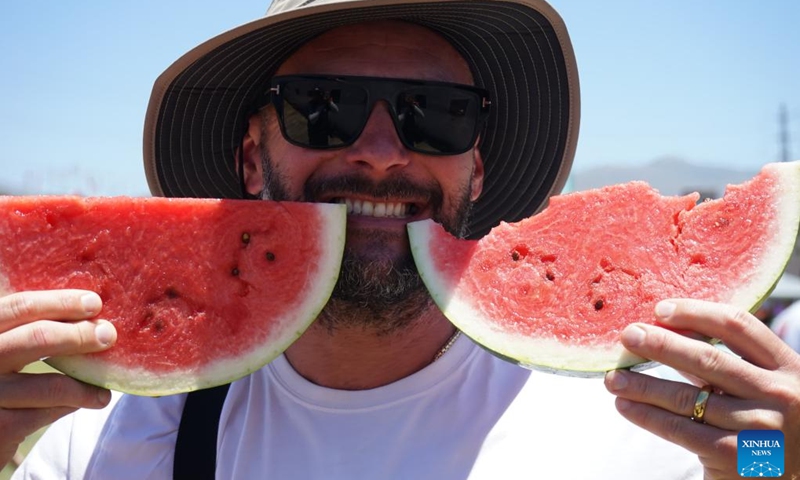A visitor poses for photos during the 2024 California Watermelon Festival in Los Angeles, California, the United States, June 22, 2024. (Photo: Xinhua)