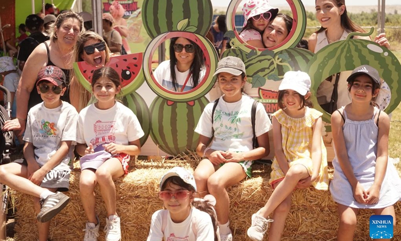 People pose for photos during the 2024 California Watermelon Festival in Los Angeles, California, the United States, June 22, 2024. (Photo: Xinhua)