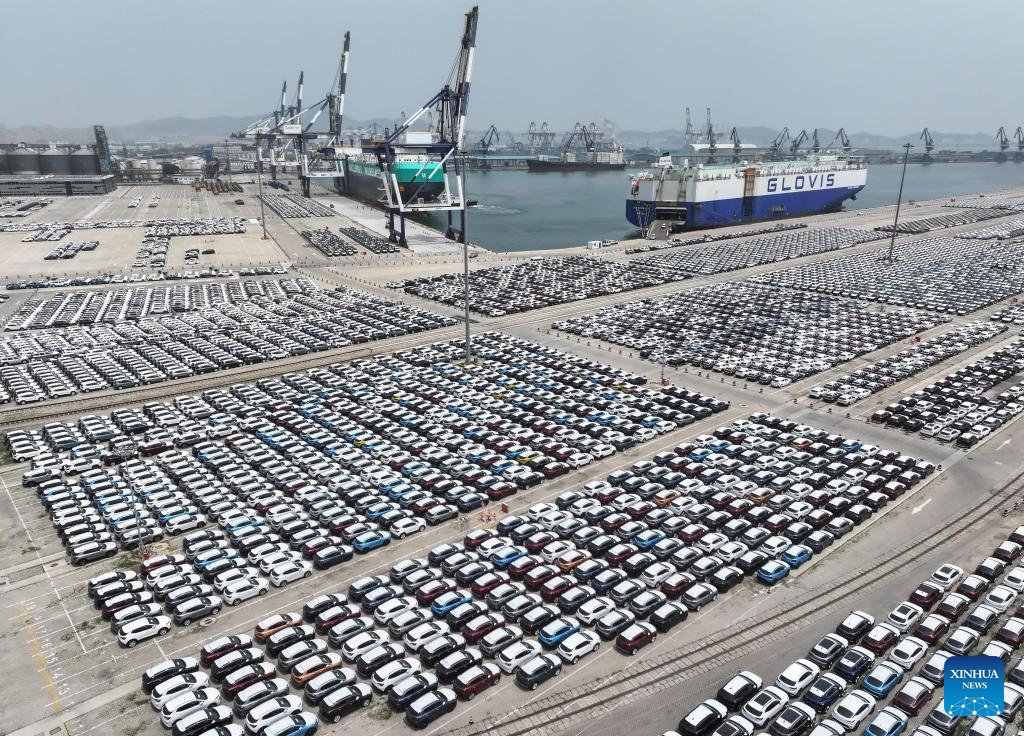 An aerial drone photo taken on June 23, 2024 shows vehicles to be loaded for transportation at Yantai Port in east China's Shangdong Province. The multi-mode handling volume of commodity vehicles of Yantai Port reached 288,000 in the first five months of 2024, an increase of 30.2 percent over the same period in 2023. In recent years, Yantai Port has stepped up efforts in building a logistic hub for commodity vehicles.(Photo: Xinhua)