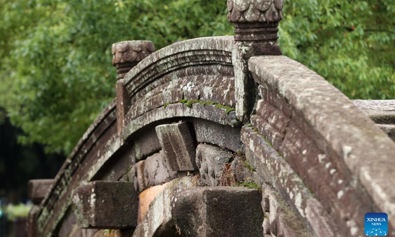 This photo taken on June 26, 2024 shows a view of the Wanshan Bridge in Shebei Village of Xin'an Town, Deqing County, east China's Zhejiang Province. Deqing County is home to seven ancient stone bridges which are listed as major cultural heritage sites under state-level protection. In recent years, the county has spared no effort in the protection and renovation of ancient stone bridges, while promoting the integration of its heritage resources with cultural tourism and research trips.(Photo: Xinhua)