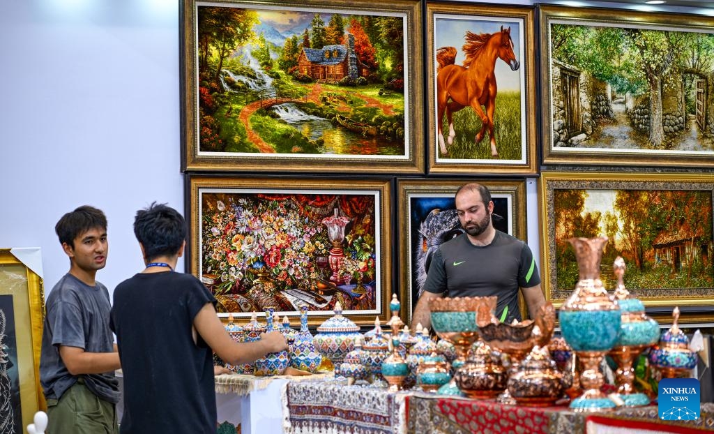 Staff members organize exhibits at the booth of Iran of the 8th China-Eurasia Expo in Urumqi, northwest China's Xinjiang Uygur Autonomous Region, June 25, 2024. The 8th China-Eurasia Expo will be held from June 26 to 30 in northwest China's Xinjiang. The expo will cover an area of 140,000 square meters with four major exhibition zones covering investment cooperation, international exhibition, special industries, and equipment manufacturing.(Photo: Xinhua)
