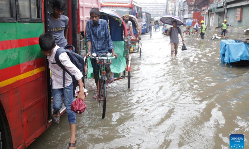 People and vehicles are pictured on a flooded road in Dhaka, Bangladesh, July 2, 2024. Recently, continuous rain has drenched the capital city, causing severe waterlogging. (Photo: Xinhua)