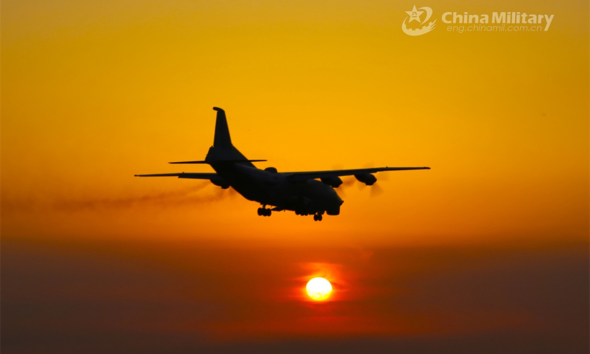 A reconnaissance aircraft attached to a PLA naval aviation regiment flies past the setting sun during a round-the-clock flight training exercise. (eng.chinamil.com.cn/Photo by Li Yang)