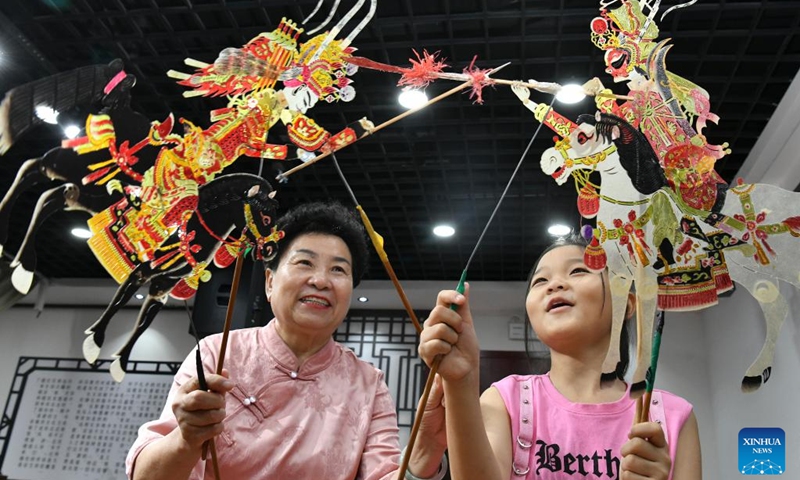 A pupil learns to play shadow puppet at a primary school in Hejian, north China's Hebei Province, July 26, 2024. Various training courses on intangible cultural heritages as shadow puppet, porcelain carving etc. targeting the school children are opened in the city during the summer vacation. Photo: Xinhua