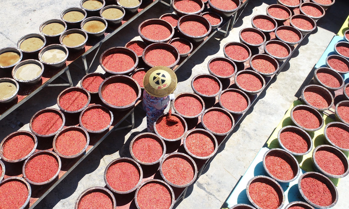 A farmer stirs chili sauce being sun-dried in the city of Loudi, Central China's Hunan Province, on July 8, 2024. With the onset of high temperatures, producers and farmers have begun sun-drying chili sauce, made from locally grown Red Lantern chili peppers, a centuries-old protected regional product.
Photo: VCG