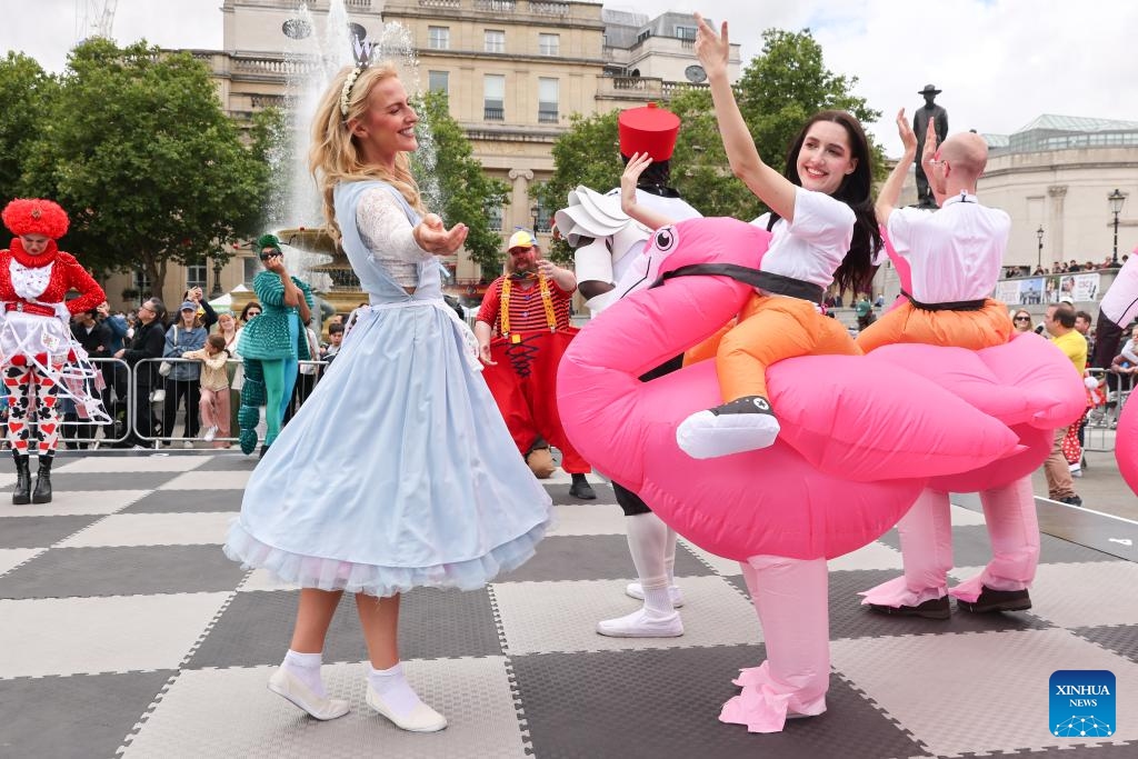 Performers dressed as Alice Through the Looking Glass characters play on a giant chess board during the ChessFest at the Trafalgar Square in London, Britain, July 7, 2024. ChessFest, an annual open-air chess festival in Britain, took place in London on Sunday. (Photo: Xinhua)