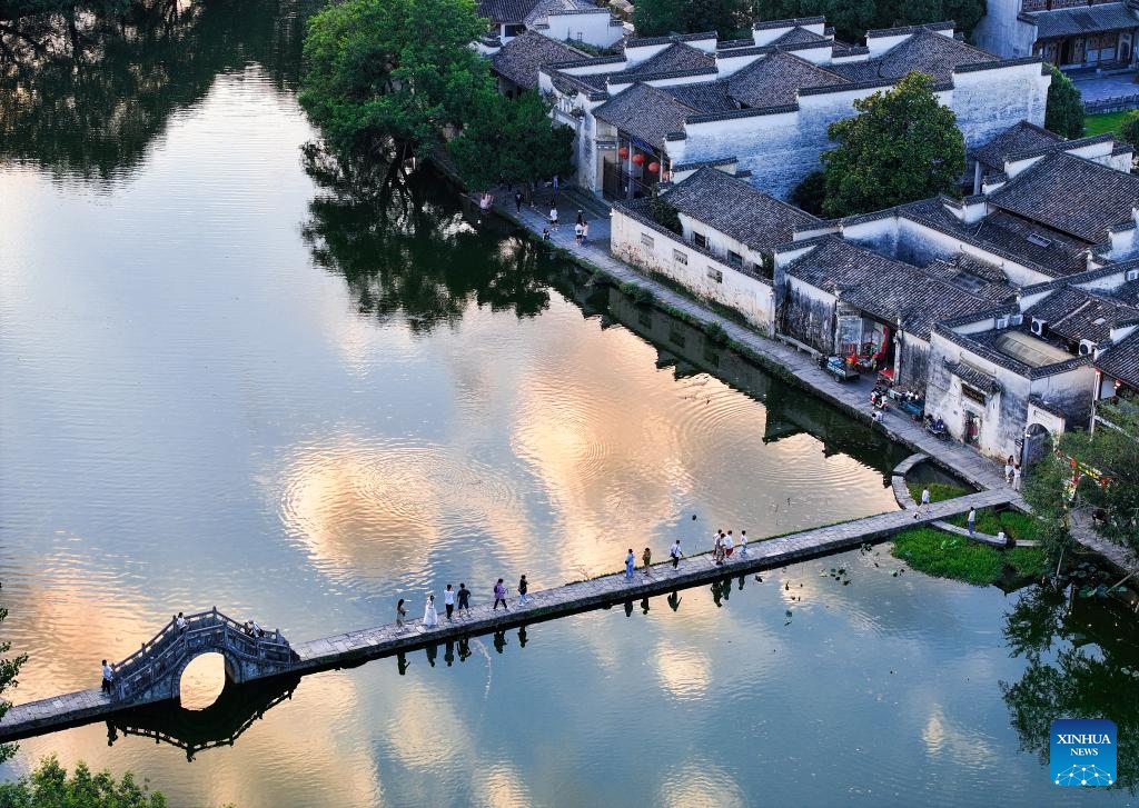 An aerial drone photo taken on July 7, 2024 shows tourists walking on a bridge in Hongcun Village of Yixian County, east China's Anhui Province. (Photo: Xinhua)