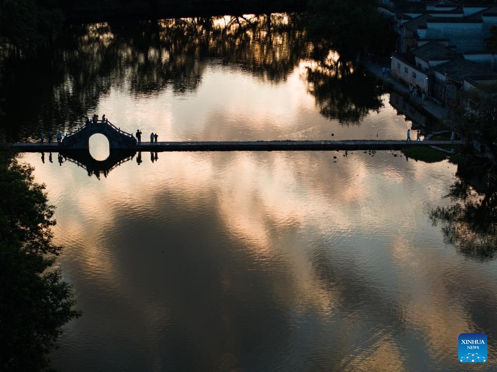 An aerial drone photo taken on July 7, 2024 shows tourists walking on a bridge in Hongcun Village of Yixian County, east China's Anhui Province. (Photo: Xinhua)