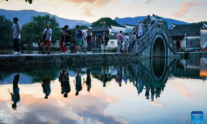 Tourists walk on a bridge in Hongcun Village of Yixian County, east China's Anhui Province, July 7, 2024. (Photo: Xinhua)