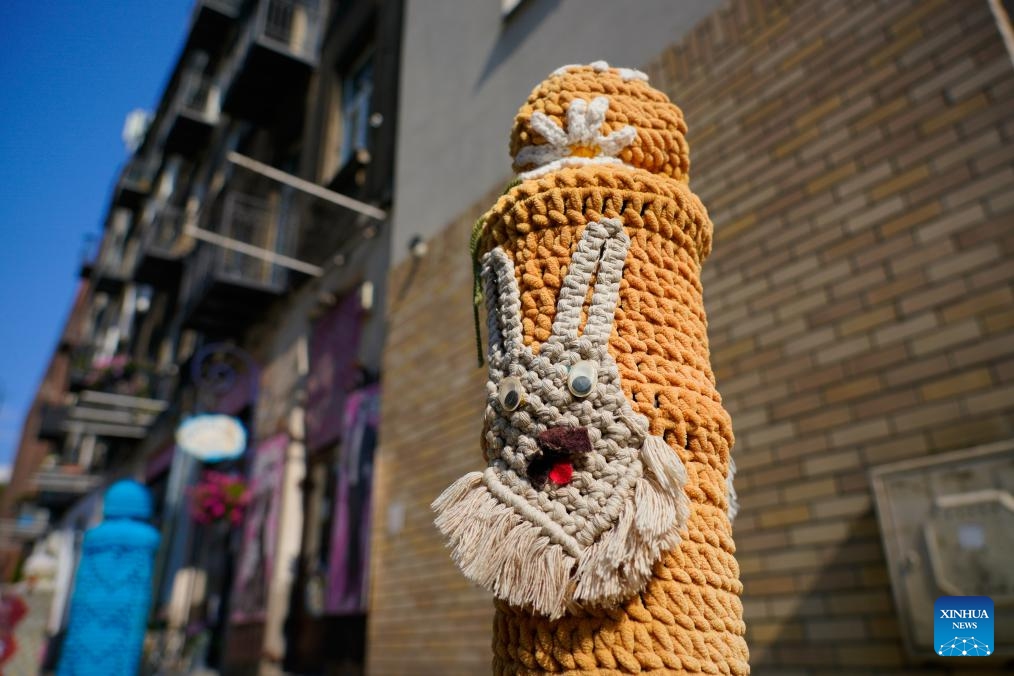 This photo taken on July 11, 2024 shows a bollard adorned with woven fabric by artisan in Praga district in Warsaw, capital of Poland. The Praga district is renowned for its vibrant cultural and creative atmosphere, with numerous galleries, museums, and designer studios. (Photo: Xinhua)