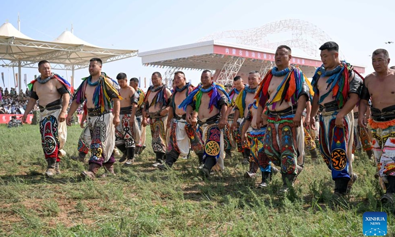 Wrestlers of traditional Mongolian style perform during the opening ceremony of the 34th Naadam festival in Xilin Gol League, north China's Inner Mongolia Autonomous Region, July 14, 2024.