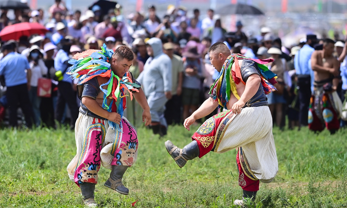 Two wrestlers compete during the opening day of the 34th Naadam Festival in the Xilingol League, North China's Inner Mongolia Autonomous Region, on July 14, 2024. 