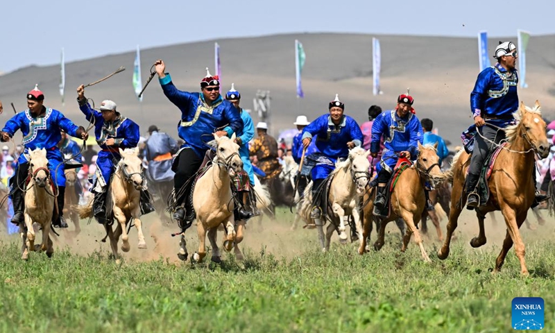 Artists perform on horseback during the opening ceremony of the 34th Naadam festival in Xilin Gol League, north China's Inner Mongolia Autonomous Region, July 14, 2024.