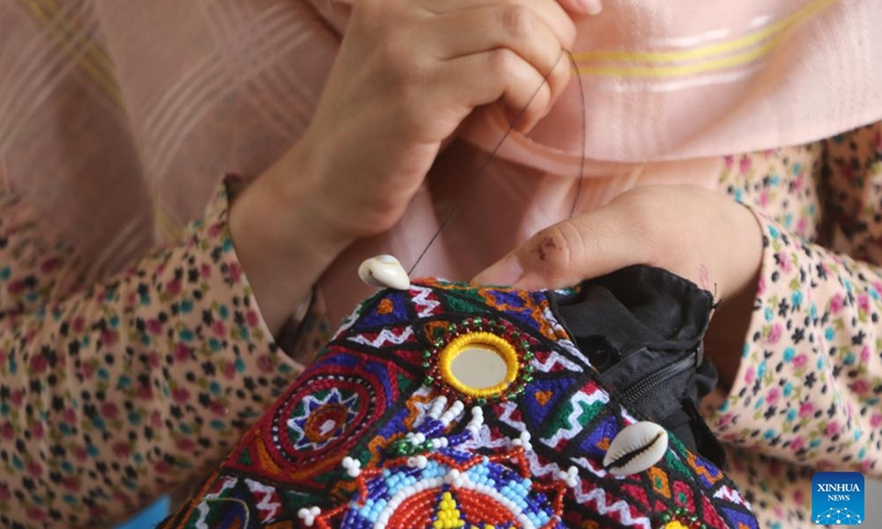 A woman works on traditional clothes at a tailor workshop run by a woman entrepreneur in Jawzjan province, Afghanistan, July 14, 2024. (Photo by Ahmad Zubair/Xinhua)