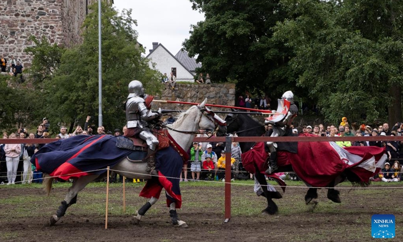 Contestants in heavy armors compete during the Turku Castle Tournament 2024 in Turku, Finland, July 14, 2024. The 4-day tournament concluded here on Sunday. (Photo: Xinhua)