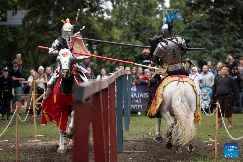 Contestants in heavy armors compete during the Turku Castle Tournament 2024 in Turku, Finland, July 14, 2024. The 4-day tournament concluded here on Sunday. (Photo: Xinhua)