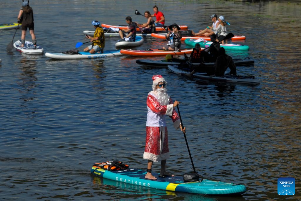 People take part in a fancy dressed SUP(Stand Up Paddle) surfing festival in Moscow, Russia, on July 14, 2024. (Photo: Xinhua)