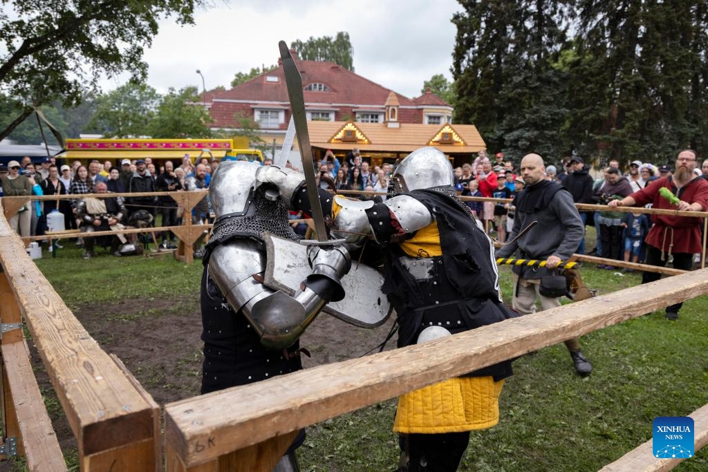 Contestants in heavy armors compete during the Turku Castle Tournament 2024 in Turku, Finland, July 14, 2024. The 4-day tournament concluded here on Sunday. (Photo: Xinhua)