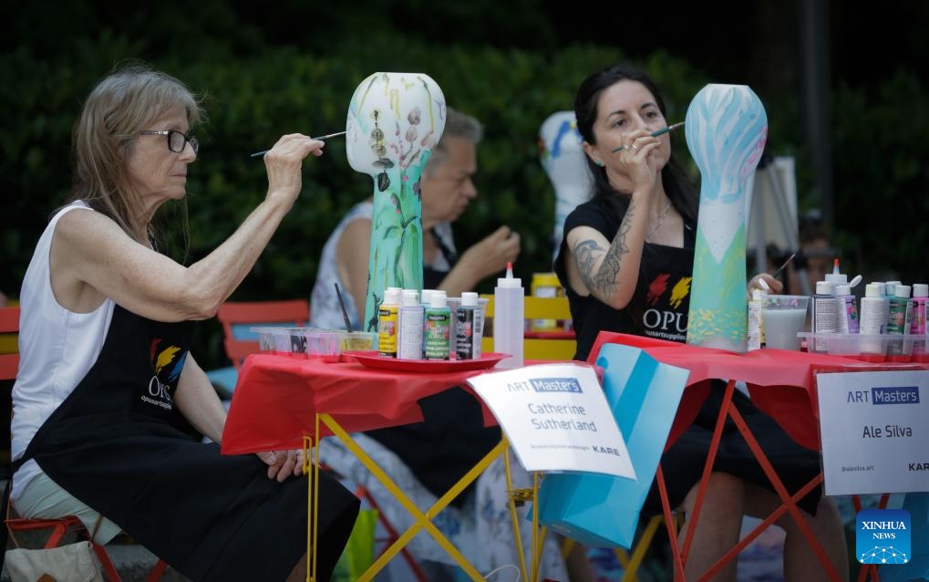 Artists work on their paintings on vases during the Art Masters painting competition in Vancouver, British Columbia, Canada, on July 17, 2024. The Art Masters is a painting competition with professional artists completing their works within one hour by using various supplies other than brushes. (Photo: Xinhua)