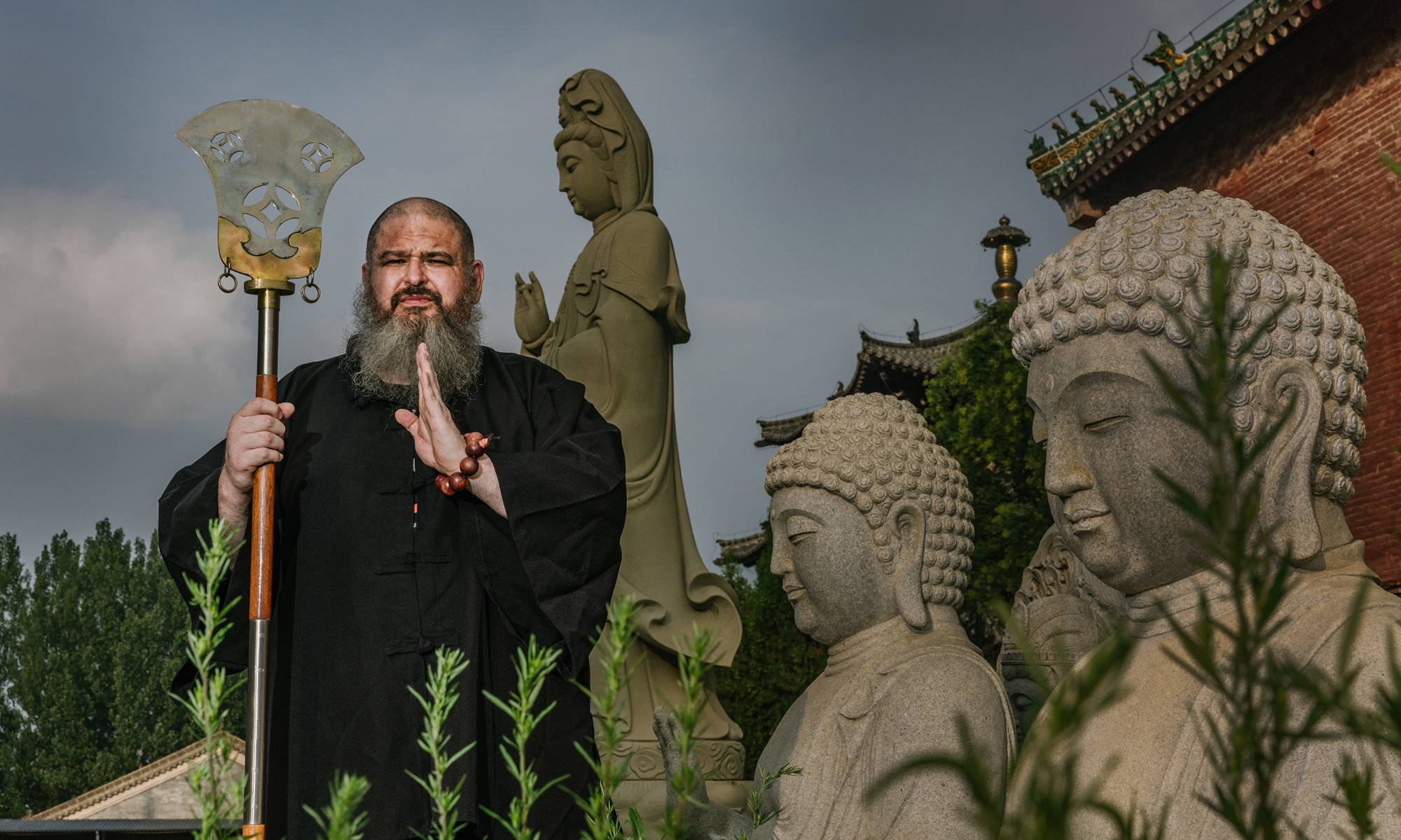 Luis Mello, a kung fu master from Brazil, poses in front of some Guanyin statues deep inside the Shaolin Temple in Dengfeng county, Central China's Henan Province on July 13, 2024. Photo: Li Hao/GT.