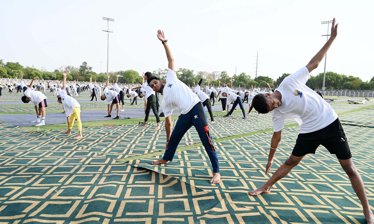 People practice yoga in Gurugram, India.  Photo: VCG