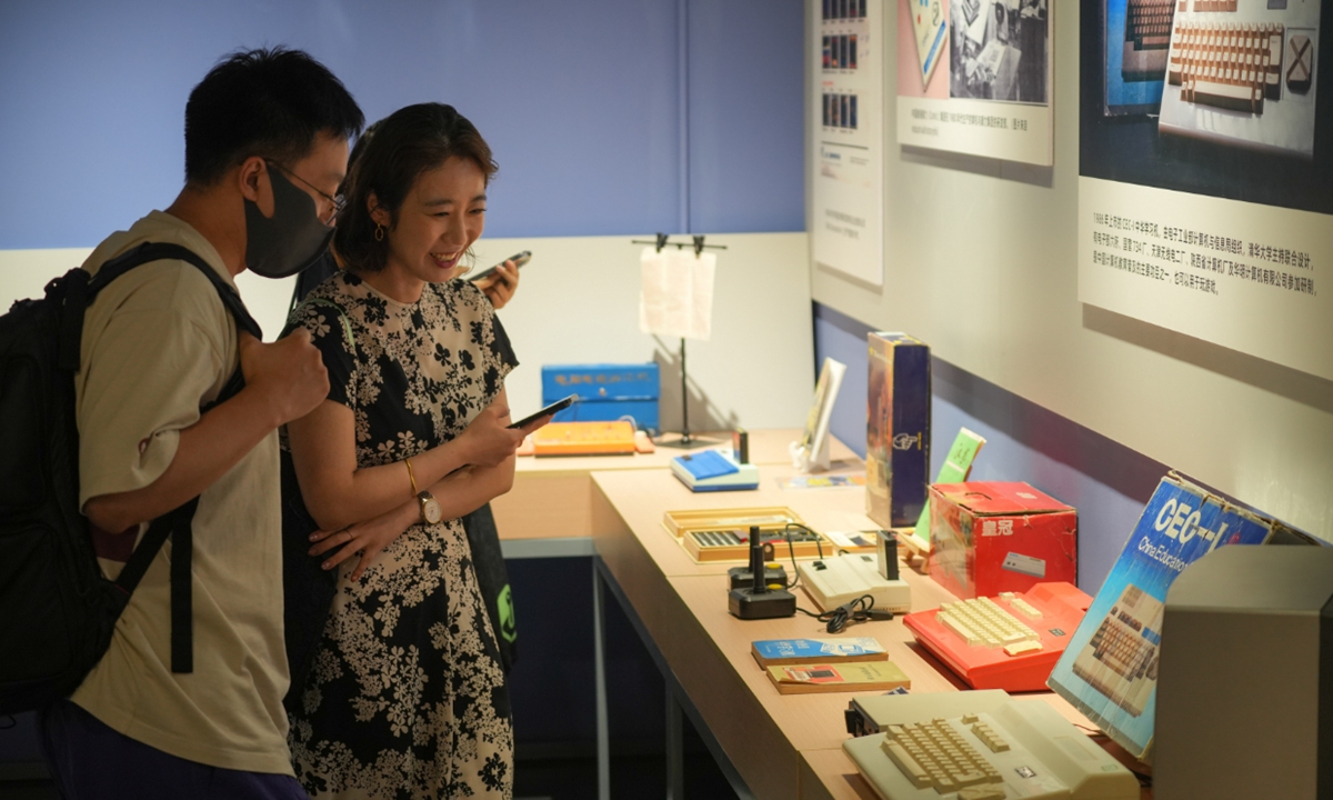 Visitors talk about an exhibit on display at the Video Game Museum of CADPA on July 25, 2024. Photo: Lu Ting/GT 