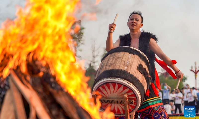 An actor beats a drum to welcome visitors at a torch festival in Chuxiong, southwest China's Yunnan Province, July 27, 2024. A torch festival of the Yi ethnic group kicked off here on Saturday. Photo: Xinhua