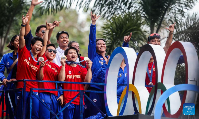 Filipino Olympians celebrate during a victory parade in Manila, the Philippines, Aug. 14, 2024. Thousands of people gathered on the streets to cheer for the Filipino athletes who competed at the 2024 Paris Olympics. (Photo: Xinhua)