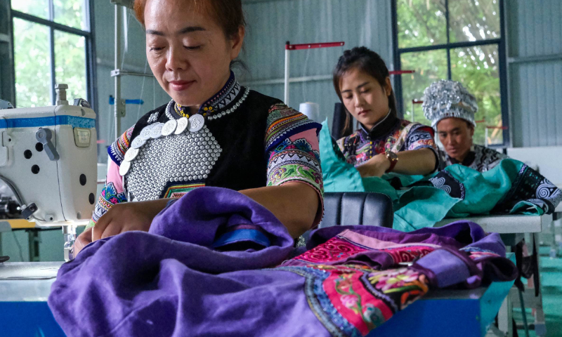 Embroiderers sew in a workshop in Honghe Hani and Yi Autonomous Prefecture, Southwest China's Yunnan Province on August 1, 2024. Local embroiderers have combined the elements of ethnic culture with modern styles in making about 300 types of products such as garments, purses, pillows, wallets and handicrafts with distinctive local ethnic characteristics. Photo: VCG