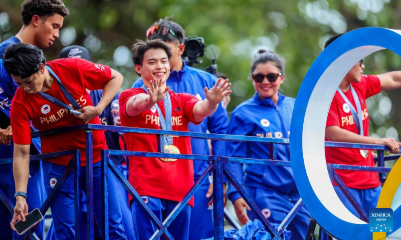 Filipino Olympians celebrate during a victory parade in Manila, the Philippines, Aug. 14, 2024. Thousands of people gathered on the streets to cheer for the Filipino athletes who competed at the 2024 Paris Olympics. (Photo: Xinhua)