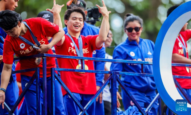 Filipino Olympians celebrate during a victory parade in Manila, the Philippines, Aug. 14, 2024. Thousands of people gathered on the streets to cheer for the Filipino athletes who competed at the 2024 Paris Olympics. (Photo: Xinhua)