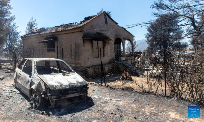 This photo shows a house and a car damaged by wildfire in Chalandri, a suburb in northern Athens, Greece, on Aug. 13, 2024. (Photo: Xinhua)
