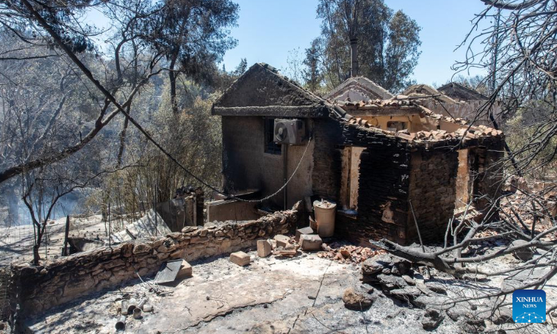 This photo shows a house damaged by wildfire in northern Athens, Greece, on Aug. 13, 2024. (Photo: Xinhua)