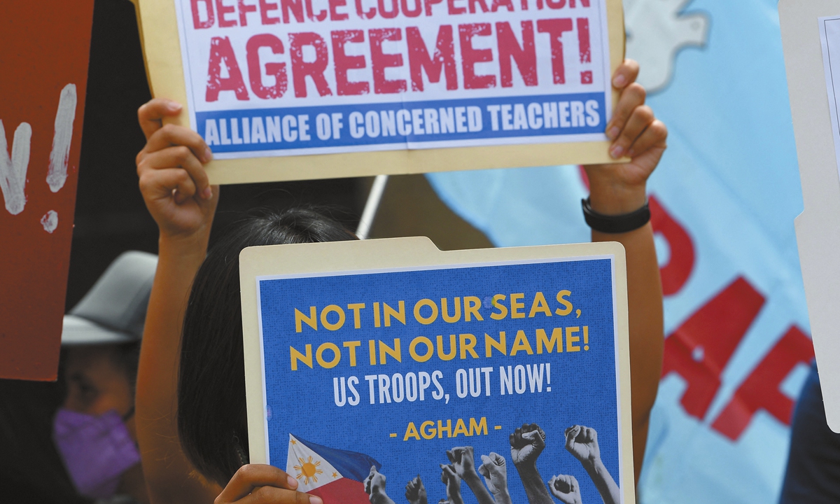 Protesters hold placards during a rally in front of the military headquarters in Manila to protest the opening ceremony of the Philippine and US annual joint military exercise, on April 22, 2024.  Photo: VCG