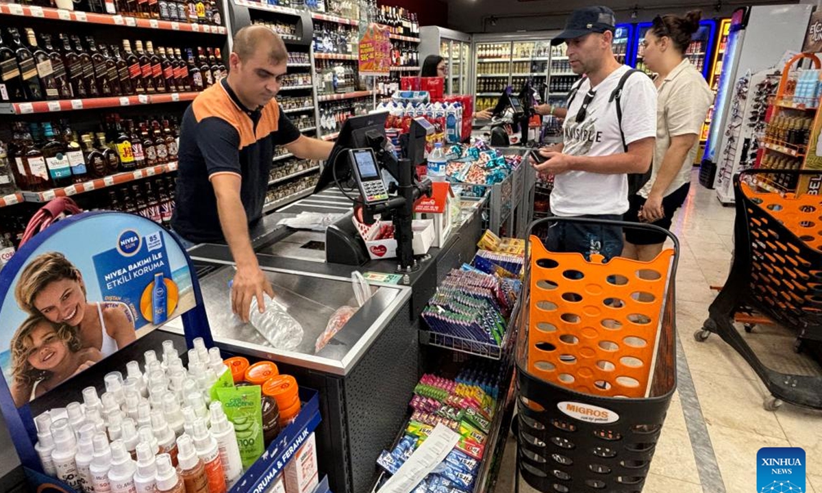 People shop at a supermarket in Ankara, Türkiye, Aug. 5, 2024. Türkiye's annual inflation rate cooled to 61.78 percent in July, marking the second consecutive month of deceleration, official data showed on Monday. (Photo: Xinhua)
