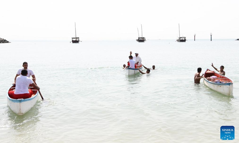 Sailors and divers head to dhow boats during the inauguration of the 33rd Pearl Diving Festival at a dock in Al-Salmiya, Hawalli Governorate, Kuwait, Aug. 10, 2024. The 33rd Pearl Diving Festival kicked off here Saturday, with up to 150 young sailors and divers boarding several dhow boats to embark on a pearl-finding trip that lasts for 6 days. Photo: Xinhua