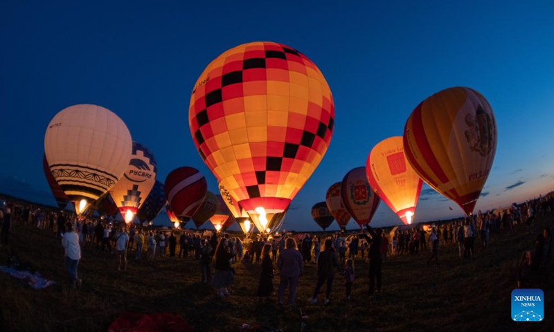 Hot-air balloons are illuminated during the Sky of Russia hot-air balloon festival in Ryazan region, Russia, on Aug. 9, 2024. The 22nd ballooning festival Sky of Russia is held here from Aug. 4 to 12, and more than 30 teams are featured in the festival. Photo: Xinhua