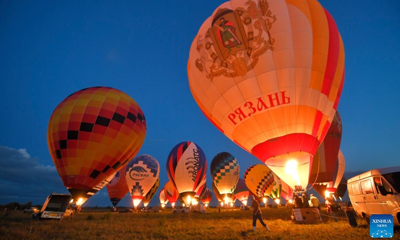 Hot-air balloons are illuminated during the Sky of Russia hot-air balloon festival in Ryazan region, Russia, on Aug. 9, 2024. The 22nd ballooning festival Sky of Russia is held here from Aug. 4 to 12, and more than 30 teams are featured in the festival. Photo: Xinhua