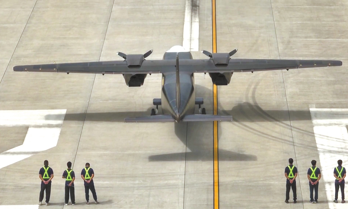 Ground crew watch as China's homegrown large twin-engine unmanned transport aircraft completes its maiden flight test in Zigong, Southwest China's Sichuan Province on August 11, 2024 (See story on Page 10). Photo: VCG