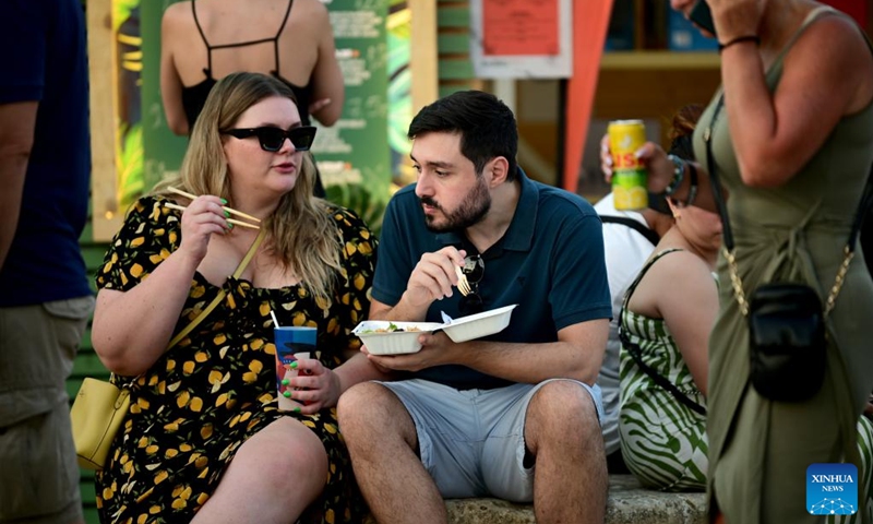 People taste food at the Malta International Food Festival in Floriana, Malta, on Aug. 11, 2024. Photo: Xinhua
