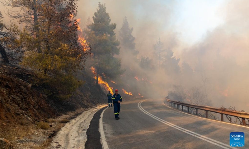 Firefighters are seen at the site of a wildfire in Varnavas, around 35 km from Athens, Greece, on Aug. 11, 2024. Greek firefighters were battling a major wildfire for several hours on Sunday near Athens, which has forced the evacuation of five settlements, the Fire Brigade said. Five residents among the evacuees were transferred to hospitals with minor injuries, mostly from respiratory problems due to smoke inhalation, said Health Minister Adonis Georgiadis. The fire broke out around 3 pm local time in Varnavas, around 35 km from Athens, in the northeastern Attica region near Marathon. Photo: Xinhua