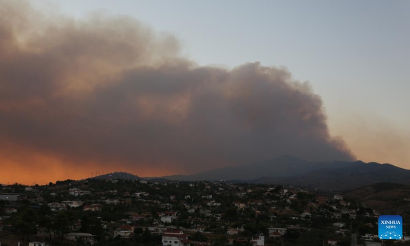 Smoke rises from a wildfire in Varnavas, around 35 km from Athens, Greece, on Aug. 11, 2024. Greek firefighters were battling a major wildfire for several hours on Sunday near Athens, which has forced the evacuation of five settlements, the Fire Brigade said. Five residents among the evacuees were transferred to hospitals with minor injuries, mostly from respiratory problems due to smoke inhalation, said Health Minister Adonis Georgiadis. The fire broke out around 3 pm local time in Varnavas, around 35 km from Athens, in the northeastern Attica region near Marathon. Photo: Xinhua