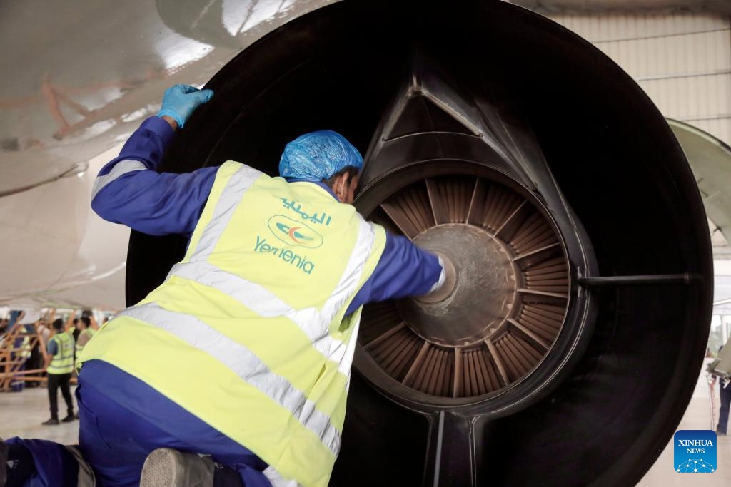 An engineer checks an aircraft at the aircraft maintenance center of the Sanaa International Airport, in Sanaa, Yemen, on Aug. 11, 2024. The General Authority of Civil Aviation and Meteorology of Yemen, along with Yemeni Airlines, announced the reopening of the plane maintenance center at the Sanaa International Airport on Sunday. （Photo: Xinhua)