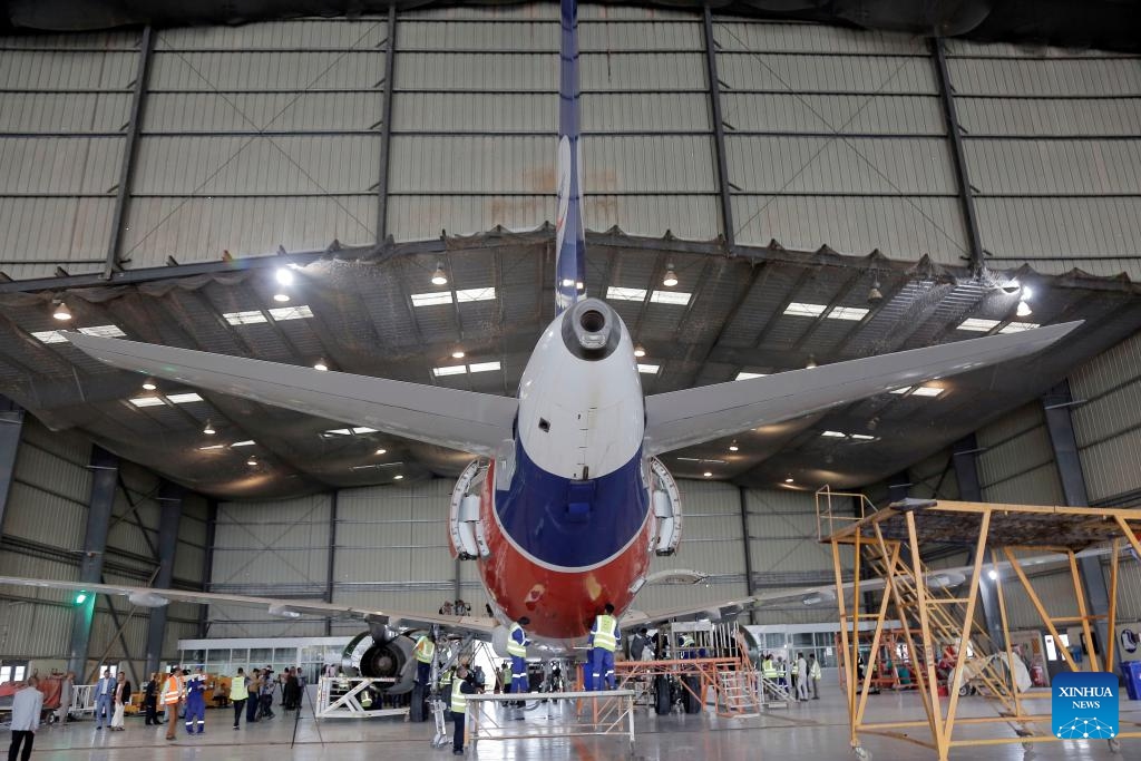 Engineers check an aircraft at the aircraft maintenance center of the Sanaa International Airport, in Sanaa, Yemen, on Aug. 11, 2024. The General Authority of Civil Aviation and Meteorology of Yemen, along with Yemeni Airlines, announced the reopening of the plane maintenance center at the Sanaa International Airport on Sunday. （Photo: Xinhua)